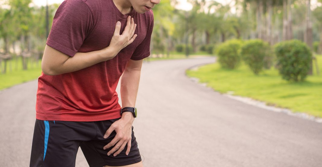 Sport man having heart attack or chest pain after running workout at park. Sport and Health care concept. Sport man having heart attack or chest pain after running workout at park. Sport and Health care concept.